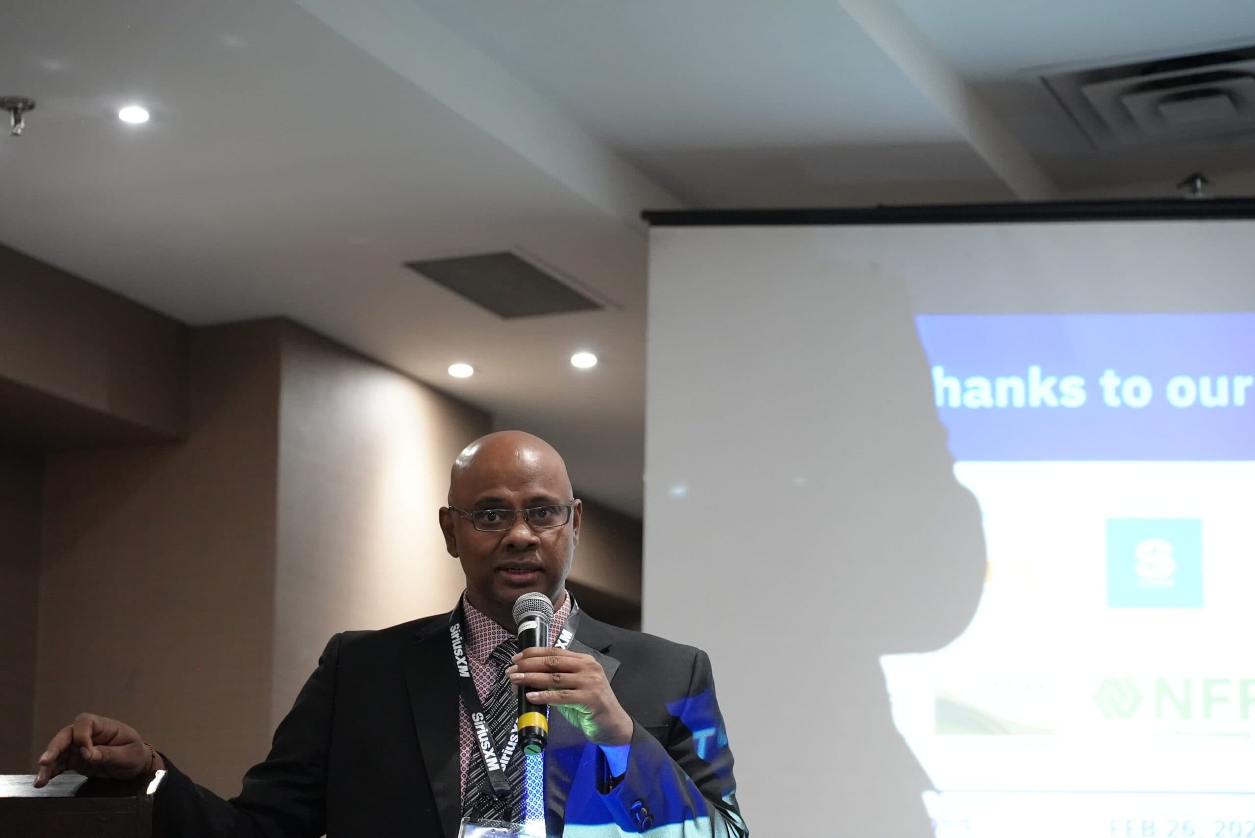 Lucky Rasappah presenting on stage